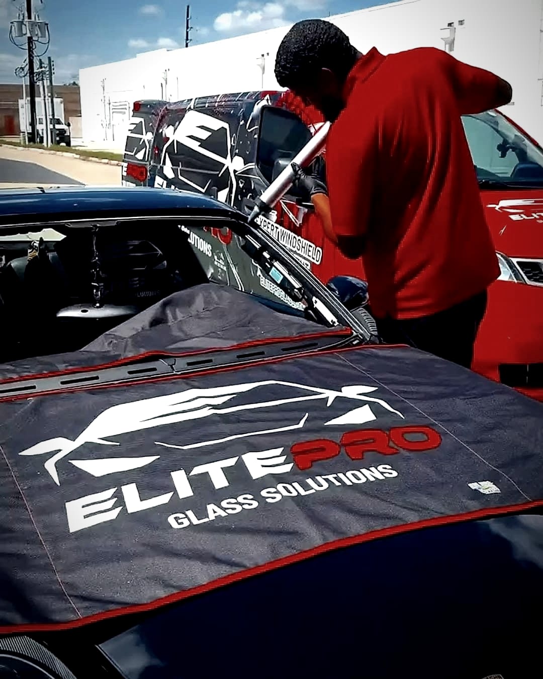 Porsche 911 under an ElitePro protective cover during glass work